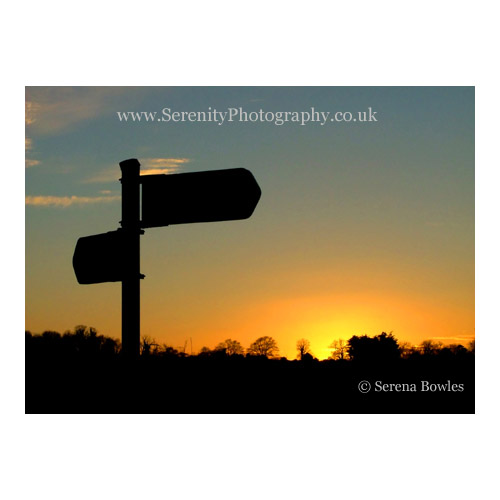 The silhouette of a road sign at sunset. Kent, England.